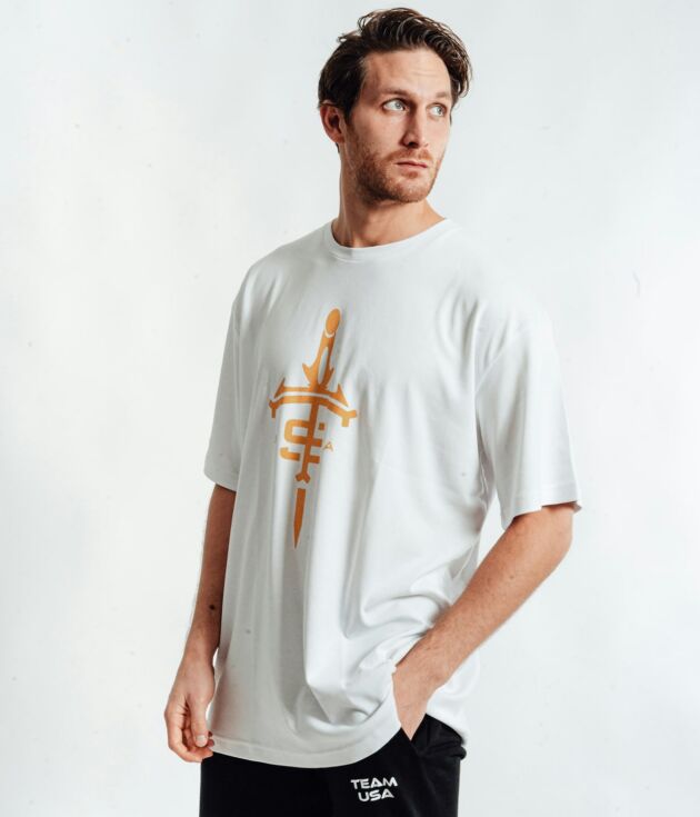 White graphic sports tee with gold emblem